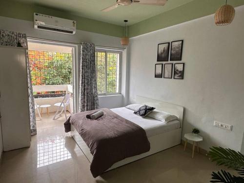 a bedroom with a bed in a room with a piano at Ozone Pvt Studio Apt with Balcony in Koregaon Park Near Osho Ashram in Pune
