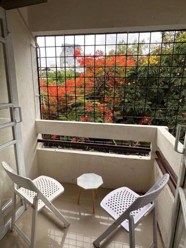 a balcony with two chairs and a window at Ozone Pvt Studio Apt with Balcony in Koregaon Park Near Osho Ashram in Pune