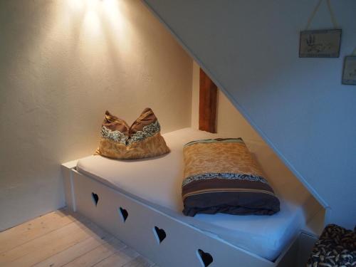 two bags sitting on a shelf under the stairs at Landhof Schober appartementen in Weissbriach
