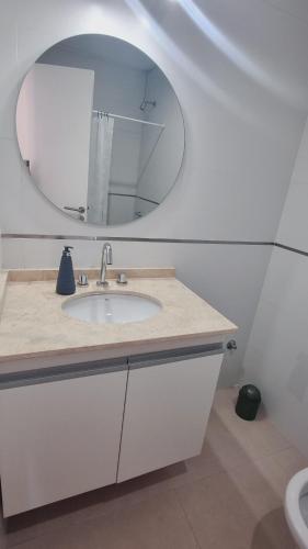 a bathroom with a sink and a mirror at Luminoso departamento en Mendoza in El Challao