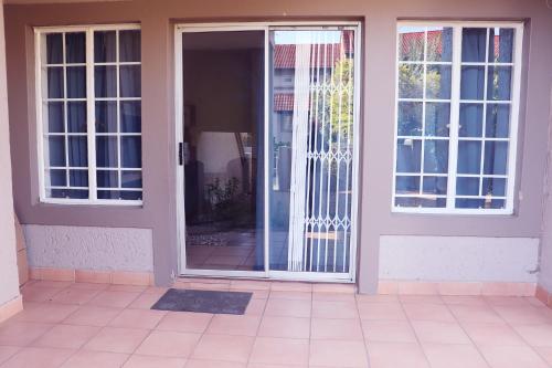 una puerta abierta en una casa con suelo de baldosa en Affordable Decent Private Room In a Shared Apartment with a Pool, en Sandton