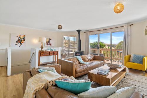 a living room with a couch and a table at Valley Views - 11 Woodgate Road in Second Valley