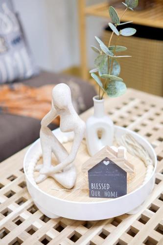 a figurine of two people sitting on a plate on a table at Skyline Stay in Manhattan in Manila