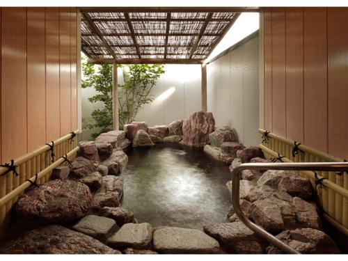 a pool of water in a room with rocks at OCEAN FRONT TATEYAMA - Vacation STAY 35718v in Tateyama