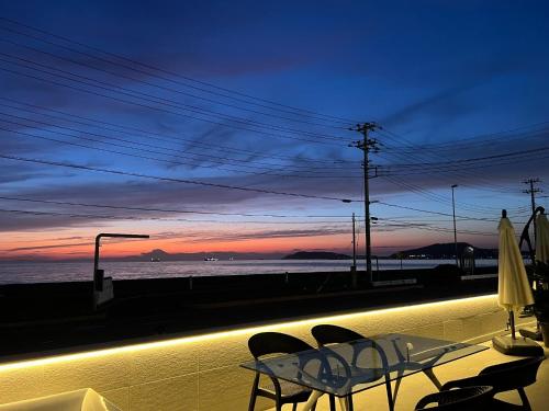 a table and chairs on a balcony with a view of the ocean at OCEAN FRONT TATEYAMA - Vacation STAY 35718v in Tateyama