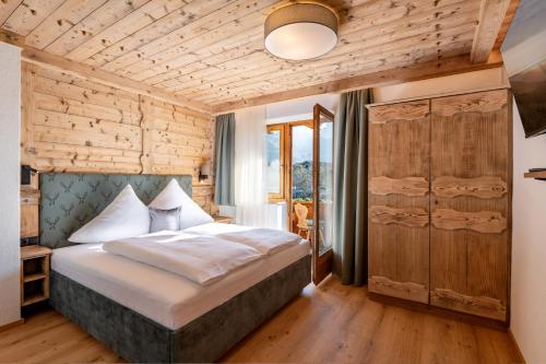 a bedroom with a bed and a wooden wall at Apartment Katharina Schneeberger in Zell am Ziller