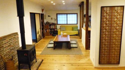 a living room with a wood stove and a couch at GETO House in Washiaimori