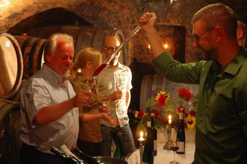 a group of people drinking wine in a wine cellar at Bio-Weingut Staffelter Hof in Kröv