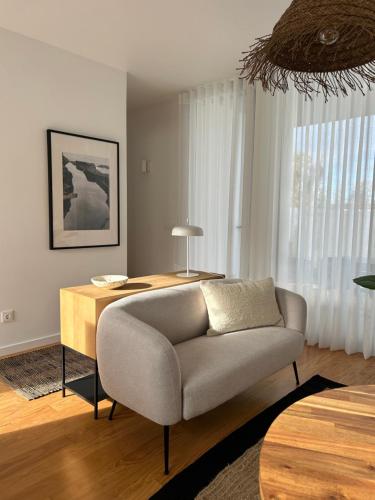 a living room with a couch and a table at Verde'Água Studio in Mosteiros