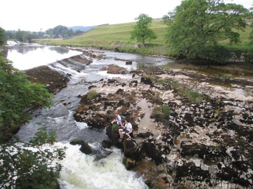 two people riding on an elephant in a river at Bridge House B & B Grassington in Grassington