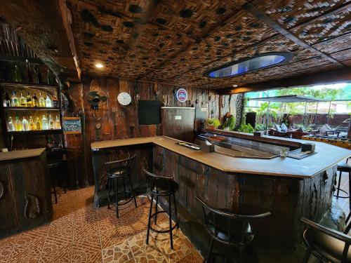 a bar in a restaurant with stools at a counter at MB's Garden Inn in Mactan