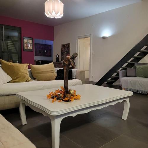 a living room with a table with a statue on it at Au vert chez Diane in Sparsbach