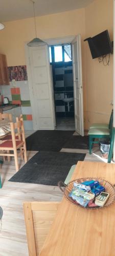 a living room with a table and a door at Sobe Zlatna Greda Motorcycle friendly in Novi Sad