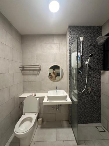 a bathroom with a toilet and a sink and a shower at FAHomestay in Kota Kinabalu