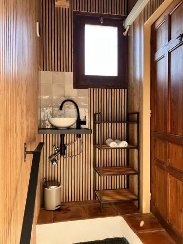 a bathroom with a sink and a window at Villa Trompetilla Montes de malaga with Yoga studio and Spa in Málaga