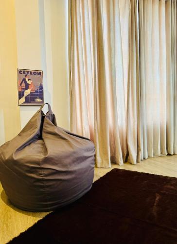 a bean bag chair sitting on the floor in front of a window at Queens Mount Glen Heights in Nuwara Eliya