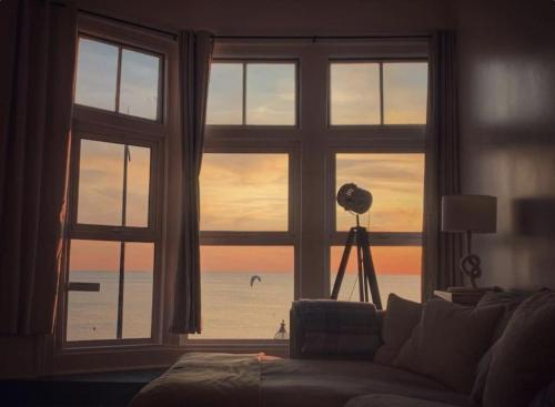 a living room with a window view of the beach at Fantastic 3 Bed Beachfront Flat with Seaview in Margate