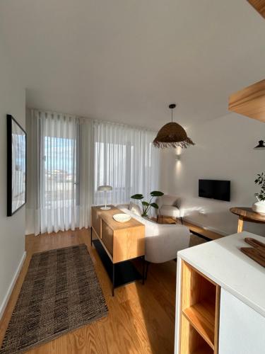 a living room with a couch and a table at Verde'Água Studio in Mosteiros