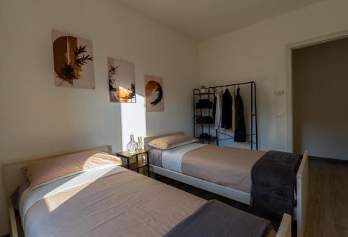 a bedroom with two beds and a closet at Orta Lake Mountain View - Il Fienile in Omegna
