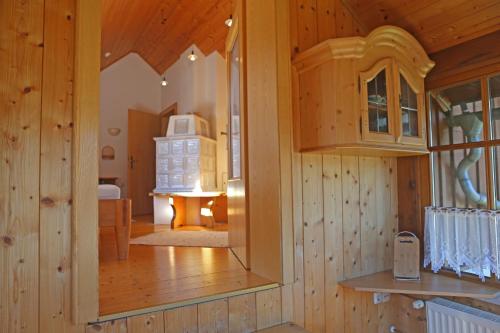 a room with wooden walls and a large mirror at Haus Leopold in Gosau