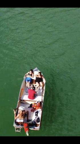 a group of people in a boat in the water at Ma. De House Lago del Turano in Valle Verde