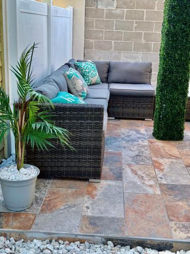 a wicker couch sitting on a patio at Bayfront Cottage- Pool - Hot Tub - Close to Beach in Port Isabel