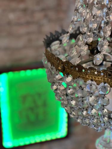 a close up of a chandelier with a green sign at Pink42 MiniStudio2 in Budapest