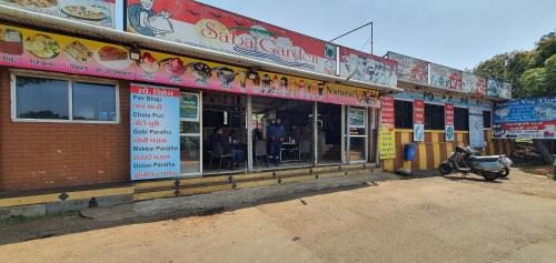 a restaurant with a motorcycle parked in front of it at Sabas Tent & Cottages in Mahabaleshwar