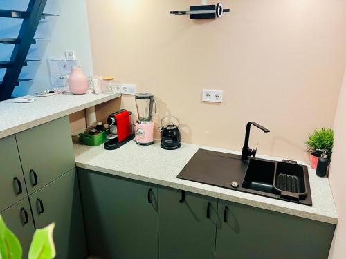 a kitchen with a sink and a counter top at Pink42 MiniStudio2 in Budapest