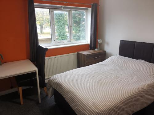 a bedroom with a bed and a window at Small double room Bromborough Wirral in Bromborough
