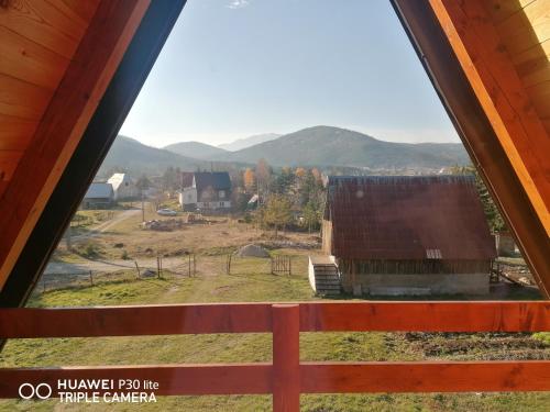 a view of a farm from a window at Vila Dajana Zminica in Žabljak