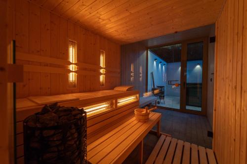 a wooden sauna with a bench and a window at Pine chalet in Smižany