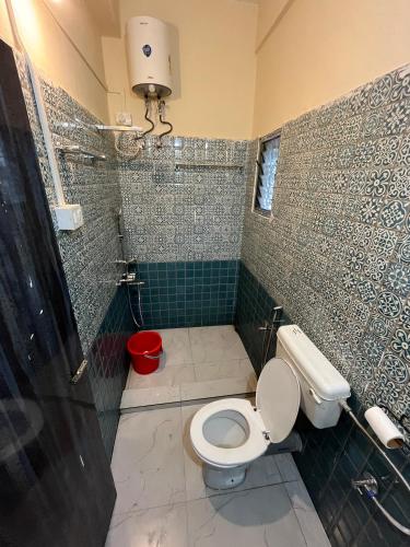 a bathroom with a toilet and a shower at Hemalata Hilltop Residency Kamakhya in Guwahati