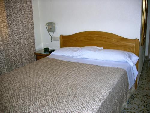 En eller flere senge i et værelse på Hotel La Parra