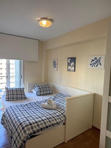 a bedroom with two beds and a window at MAGNO CULLERA- Playa in Cullera