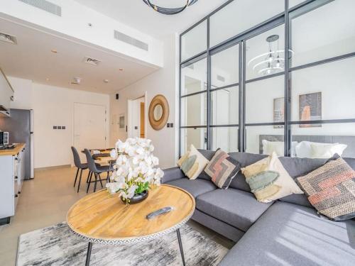 a living room with a couch and a table at Dubai Hills estate - 1Bedroom Apt in Dubai