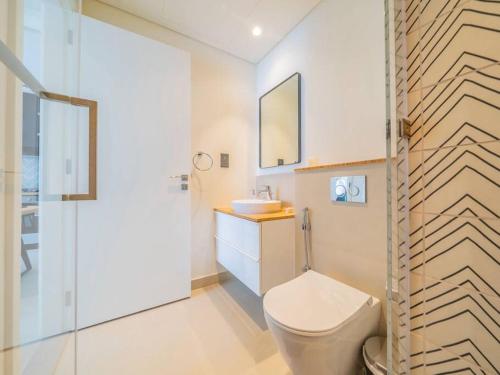 a bathroom with a toilet and a sink and a shower at Dubai Hills estate - 1Bedroom Apt in Dubai