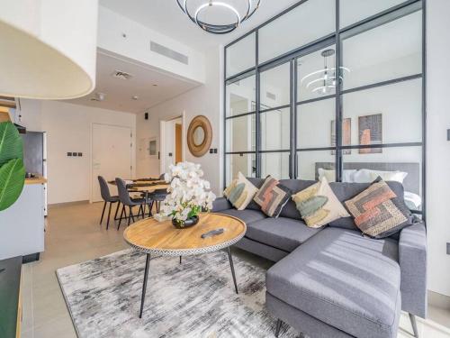 a living room with a couch and a table at Dubai Hills estate - 1Bedroom Apt in Dubai