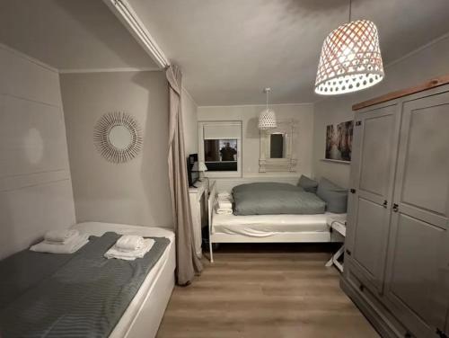 a small bedroom with two beds and a bed istg at Harz-Forest-Inn in Goslar