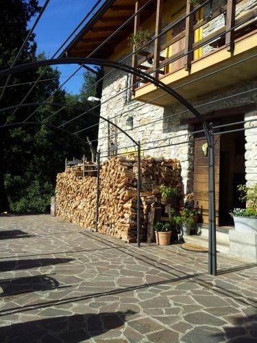 a building with a pile of fire wood at Agriturismo Cascina Ronchi in Palazzago