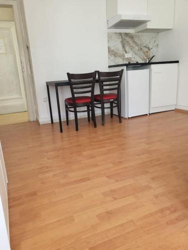 een keuken met twee stoelen en een tafel in een kamer bij Studio 1 in Luxemburg