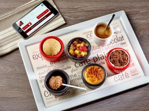 a tray with four bowls of food on a table at ibis Marseille Provence Aéroport in Marignane