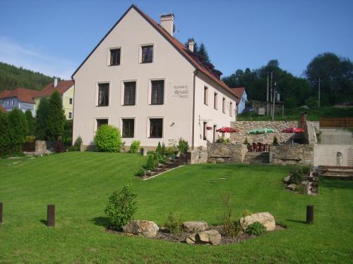 a large white house with a large yard at Rožmberk Royale Pension in Rožmberk nad Vltavou