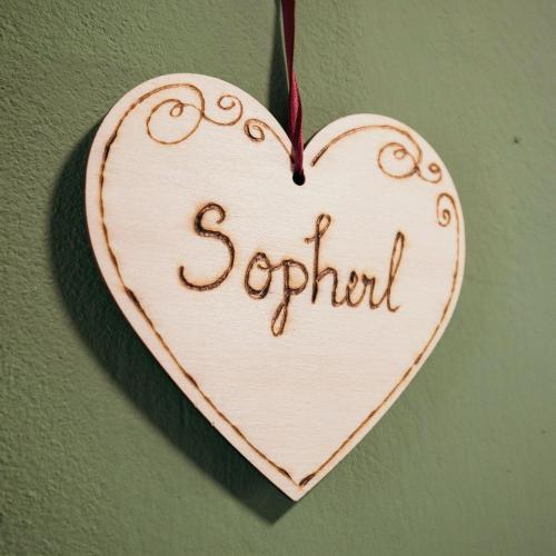 a wooden heart hanging on a wall with the word squad at Domizil Ausseerland - Your Austrian Home in Altaussee