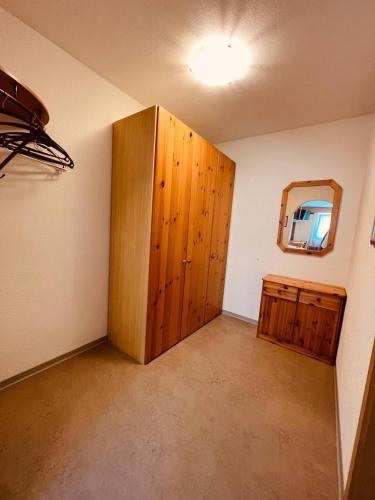 a room with a large wooden door and a mirror at SKY Rooms, Mountainous View in Saas