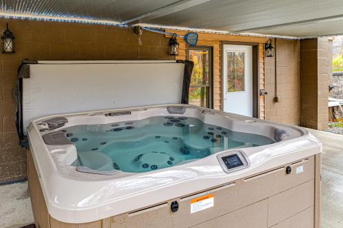 a jacuzzi tub sitting inside of a house at Family-Friendly Milton Home on 14 Acres with Hot Tub in Milton