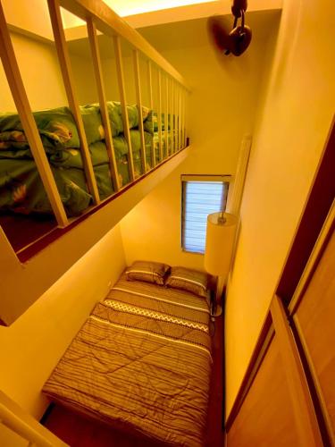 a small room with a bed in a stair case at FZ Homestay, Putrajaya Prescint 5 in Putrajaya