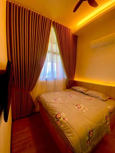 a bedroom with a bed and a window with curtains at FZ Homestay, Putrajaya Prescint 5 in Putrajaya