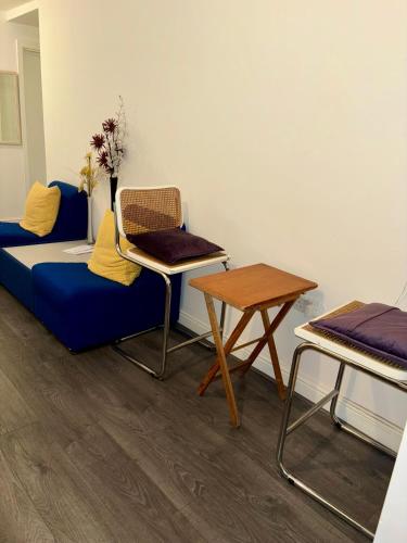 a living room with a couch and a table at Stainless Guests house in Dudley