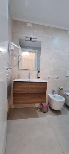 a bathroom with a tub and a sink and a mirror at La Dimora del Cuore in Mesagne
